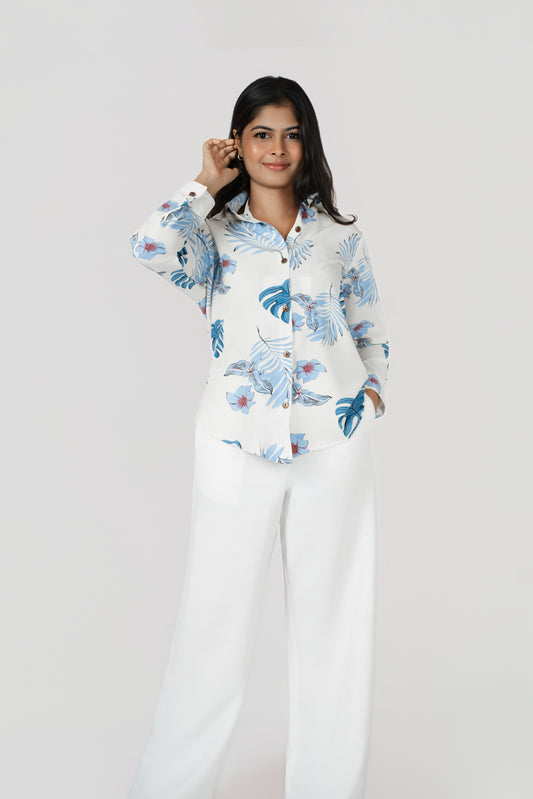 Isla Wide-Leg Linen Trousers: white 100% linen wide-leg trousers, worn with a blue leaf-print shirt, front view
