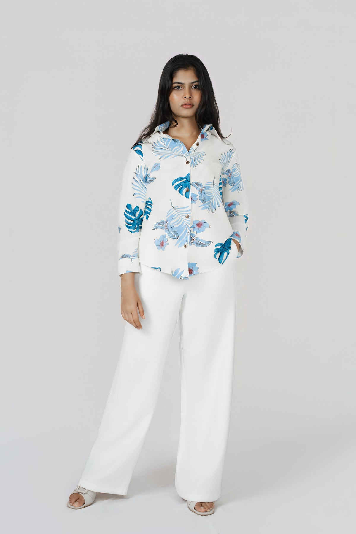 Isla Wide-Leg Linen Trousers: white 100% linen wide-leg trousers, worn with a blue leaf-print shirt, front view, full length