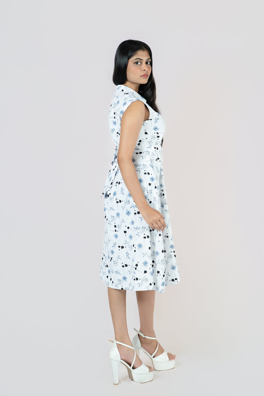 Petal Whirl Belted Dress: white sleeveless collared midi shirt dress with a scattered blue-black petal print and tie belt, side view