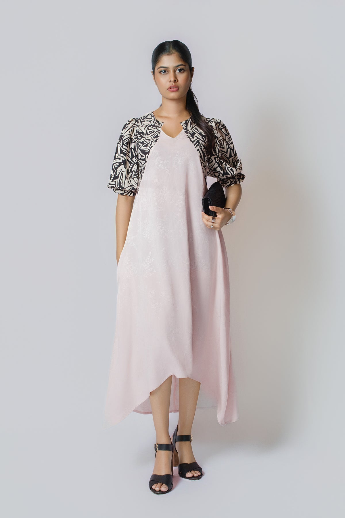 Luna Contrast Midi: pale blush midi dress with black and white patterned puff sleeves, front view