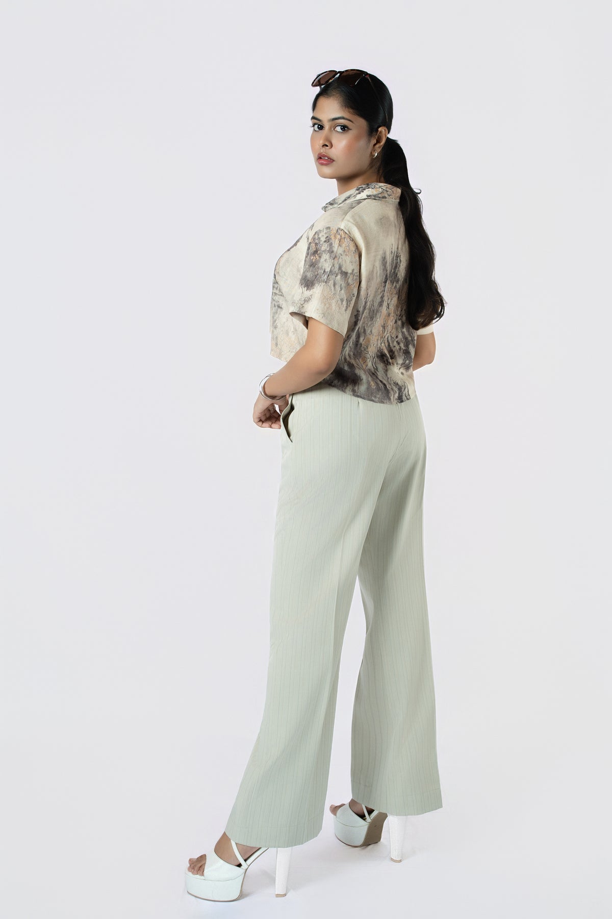 Lune Wide-Leg Trousers: sage green high-waist wide-leg cotton-linen trousers, worn with a brushstroke-print crop shirt, side view