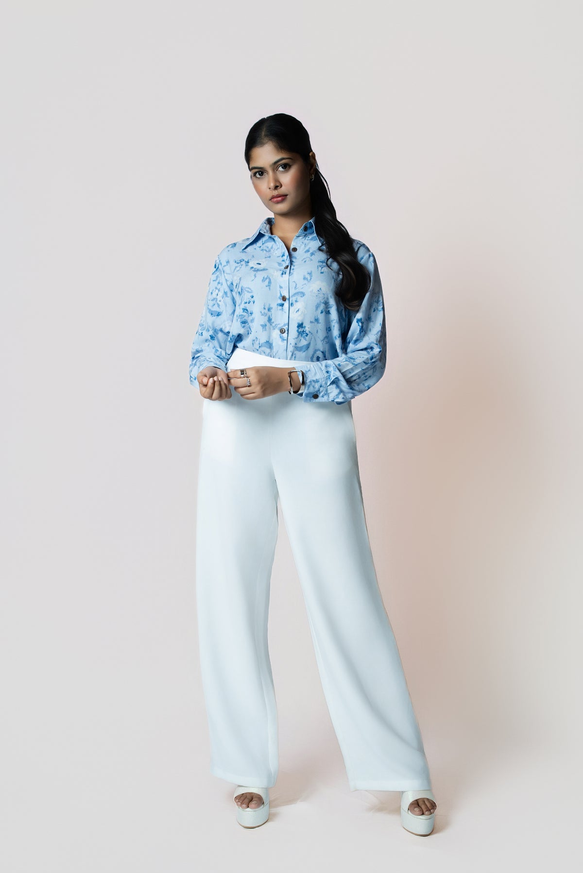 Skyline Bloom Shirt: light blue floral-print long-sleeve shirt, worn with white wide-leg trousers, front view