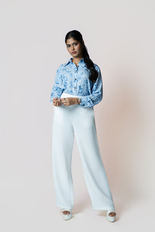 Skyline Bloom Shirt: light blue floral-print long-sleeve shirt, worn with white wide-leg trousers, front view