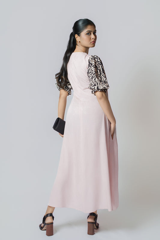 Luna Contrast Midi: pale blush midi dress with black and white patterned puff sleeves, back view