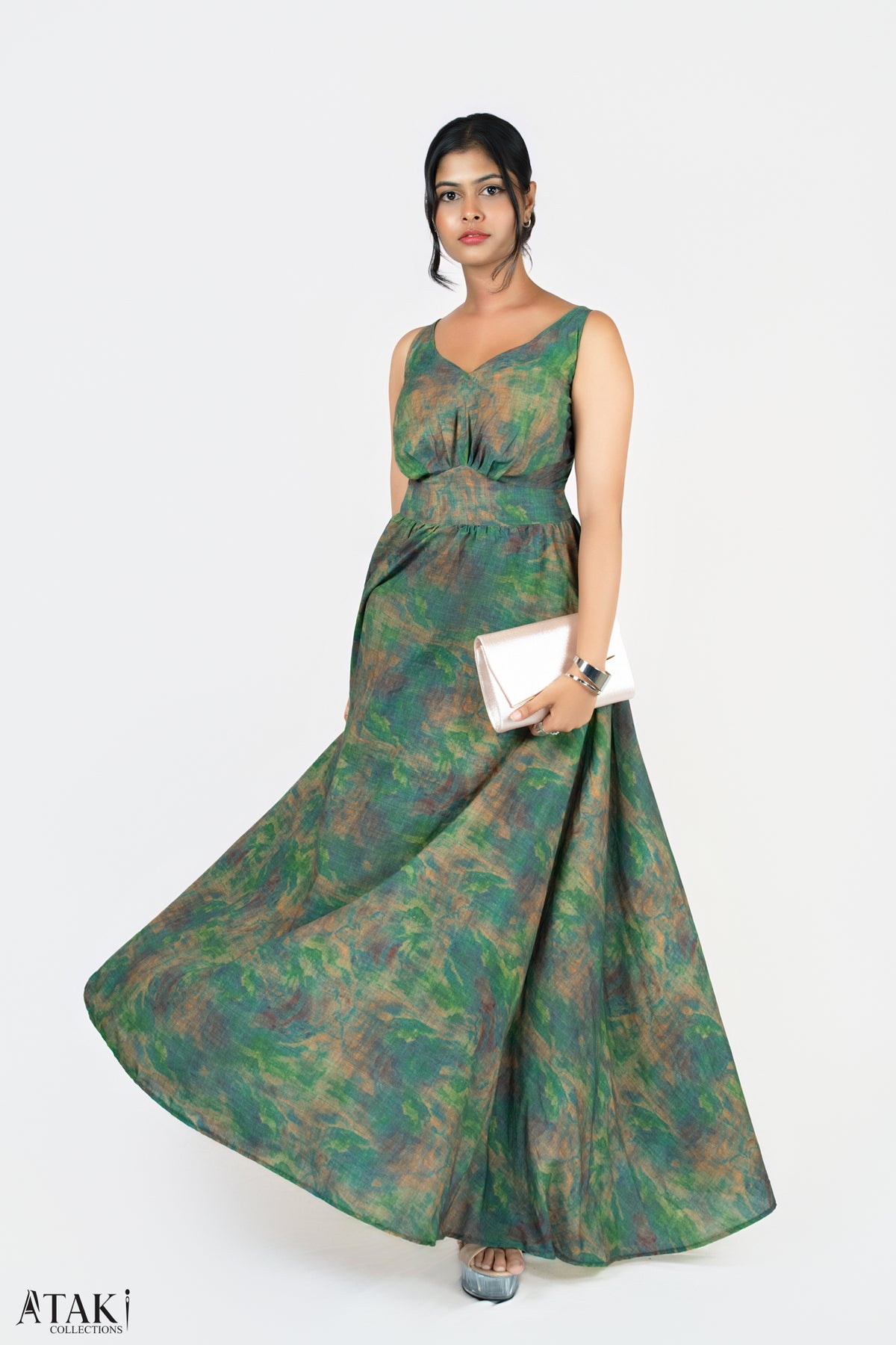 Model in a green watercolour-print sleeveless maxi dress with a full skirt