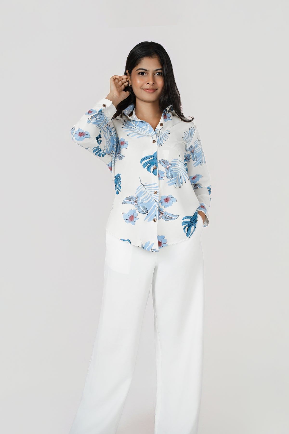 Isla Wide-Leg Linen Trousers: white 100% linen wide-leg trousers, worn with a blue leaf-print shirt, front view