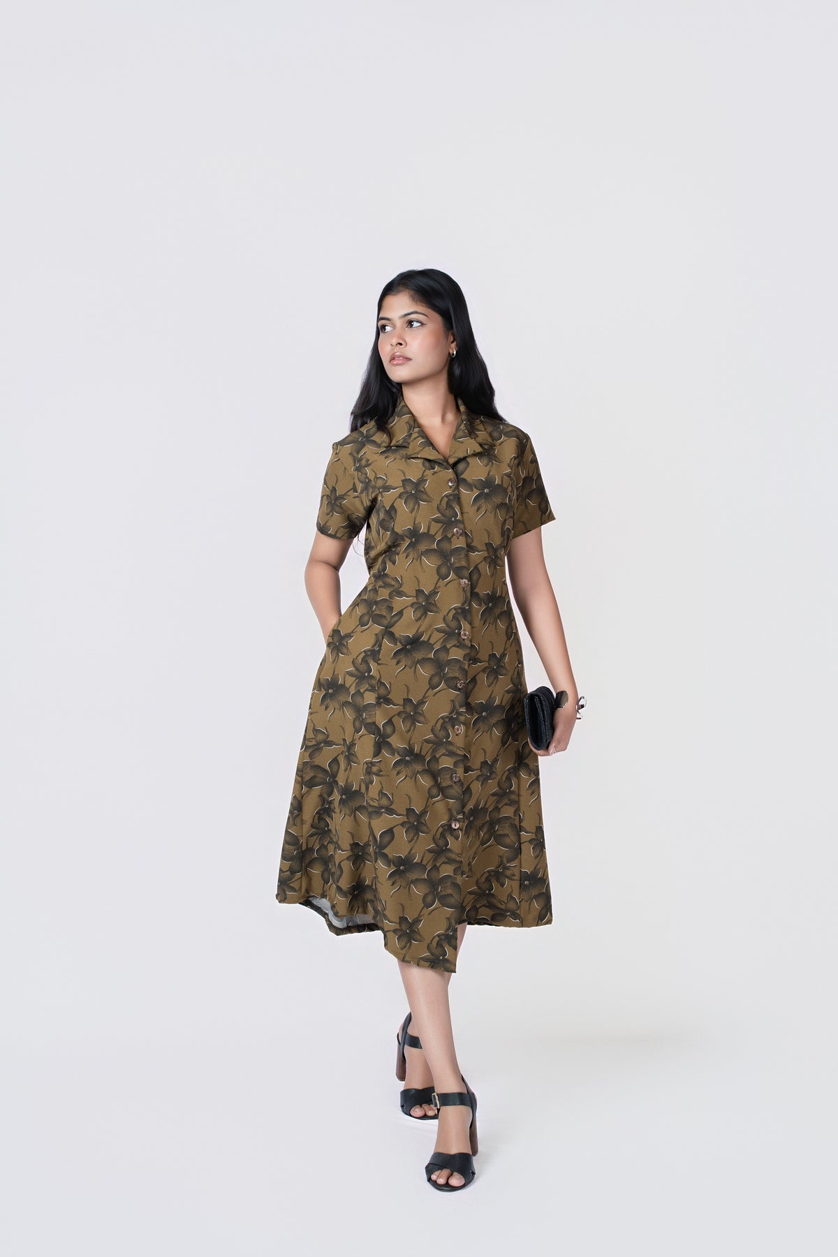 Olive Petal Button-Down Midi Dress: olive floral-print collared midi shirt dress with short sleeves and tie waist, front view, walking