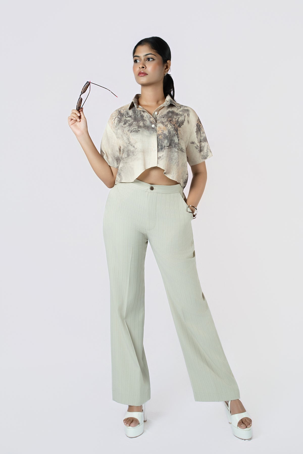 Lune Wide-Leg Trousers: sage green high-waist wide-leg cotton-linen trousers, worn with a brushstroke-print crop shirt, front view