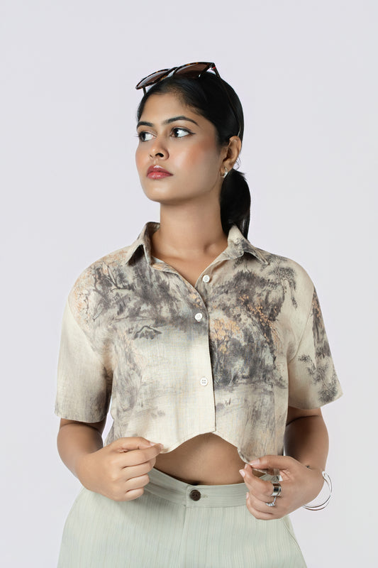 Willow Mist Crop Top: beige and grey brushstroke-print cropped cotton shirt with short sleeves, worn with sage trousers, close-up of the collar and cropped hem