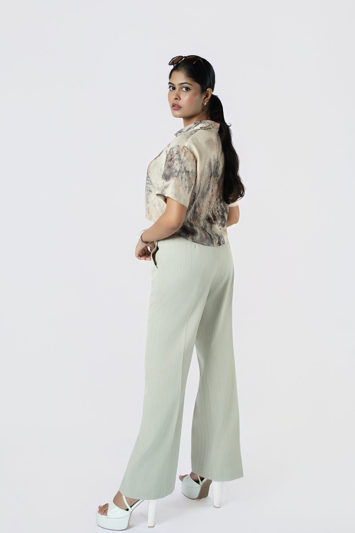 Willow Mist Crop Top: beige and grey brushstroke-print cropped cotton shirt with short sleeves, worn with sage trousers, back view