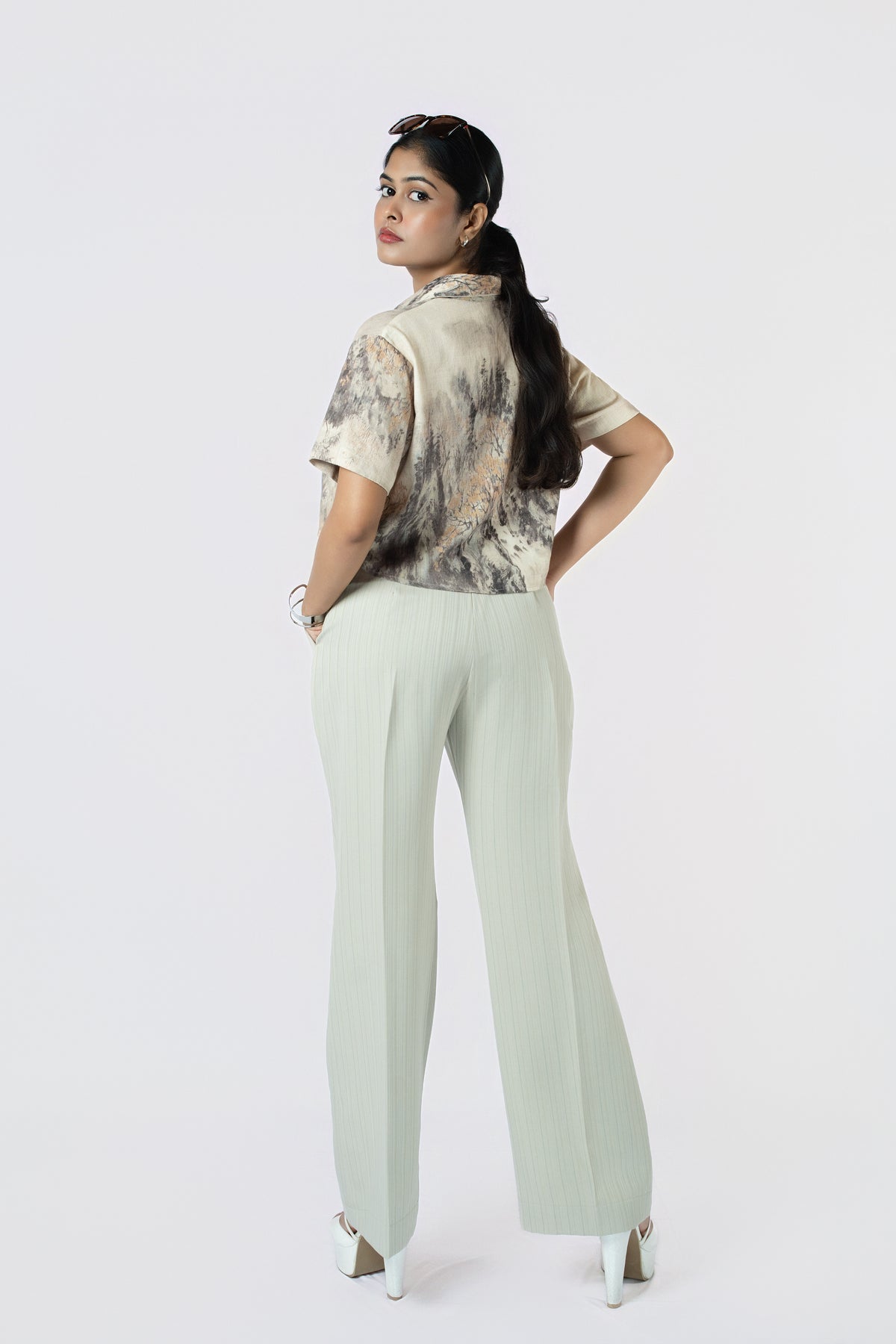 Lune Wide-Leg Trousers: sage green high-waist wide-leg cotton-linen trousers, worn with a brushstroke-print crop shirt, back view