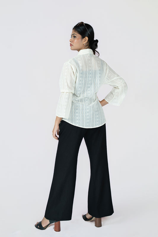 Midnight Grace Wide-Leg Trouser: black wide-leg trousers with a fluid drape, back view, styled with an ivory blouse