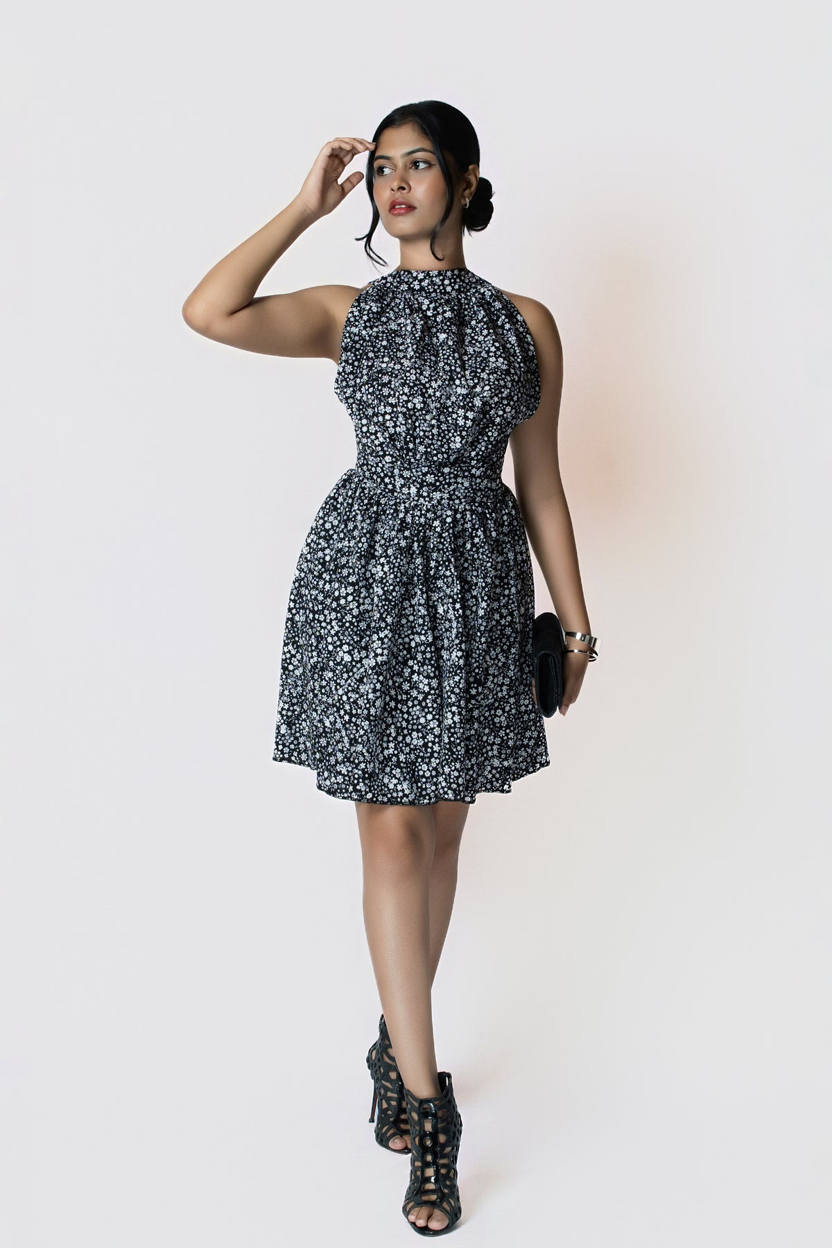 Noir Meadow Halter Dress: black and white ditsy floral halter-neck mini dress with a cinched waist, front view