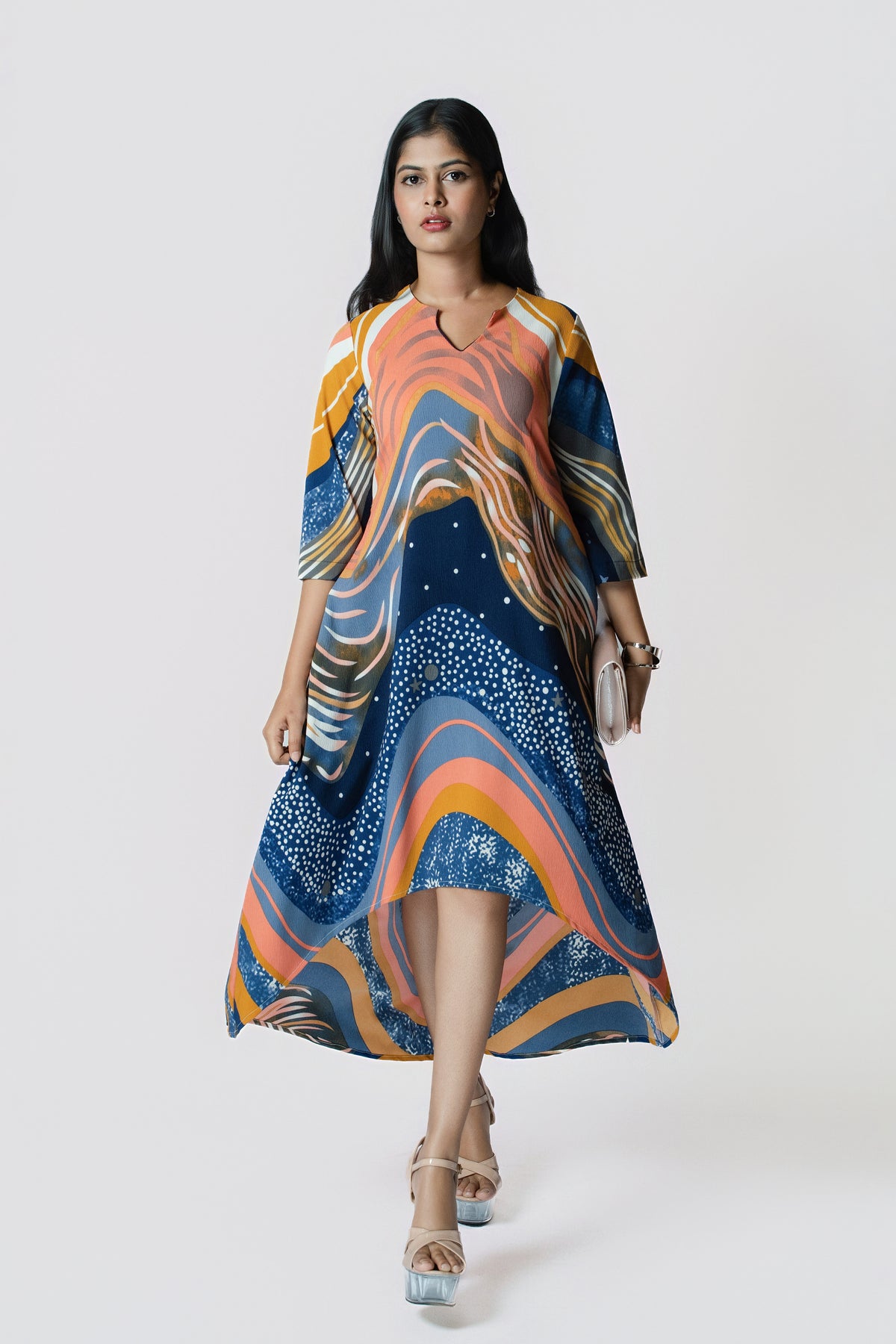 Stardust Flow Tunic: flowing tunic dress in a navy, orange and mustard wave print with a high-low hem, front view