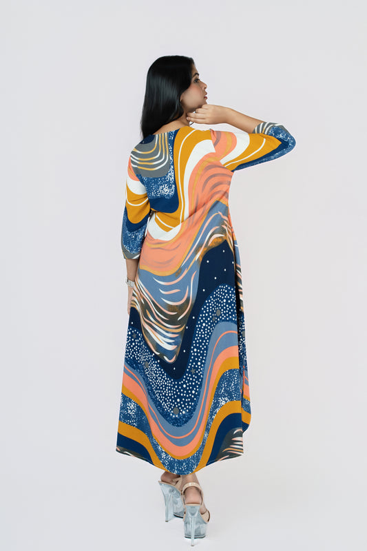 Stardust Flow Tunic: flowing tunic dress in a navy, orange and mustard wave print with a high-low hem, back view