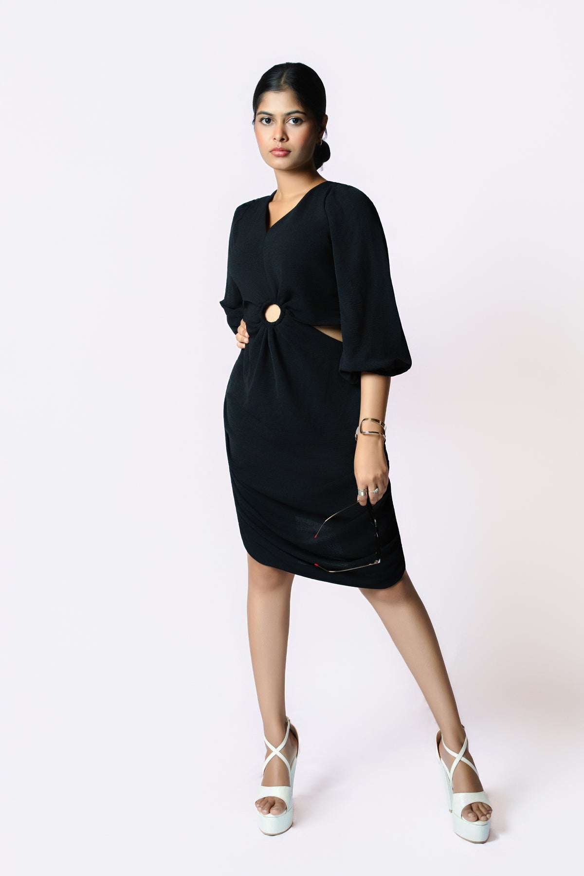 Noir Ring Detail Dress: black V-neck knee-length dress with puff sleeves and a gold ring cut-out at the waist, front view