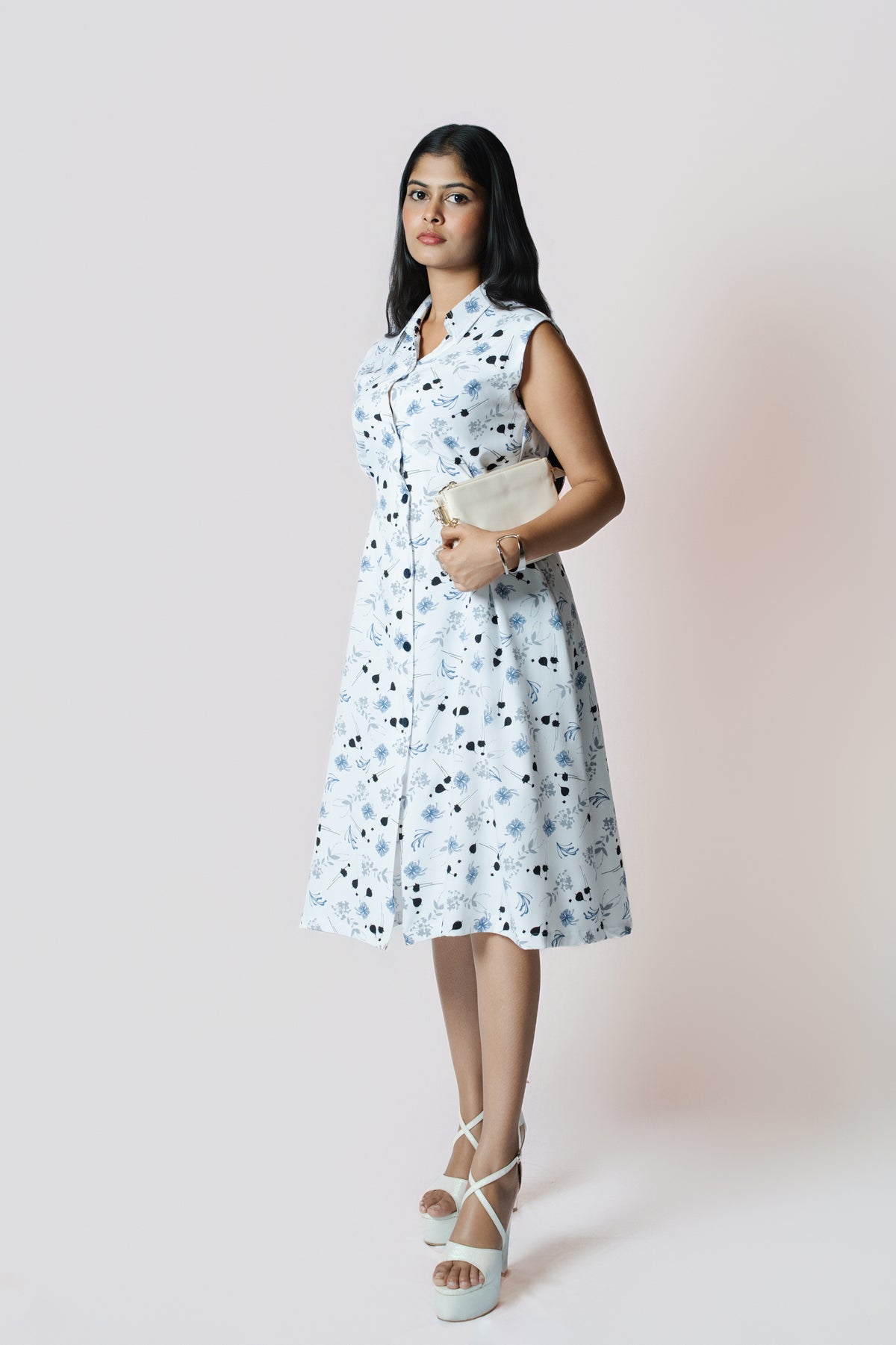Petal Whirl Belted Dress: white sleeveless collared midi shirt dress with a scattered blue-black petal print and tie belt, front view