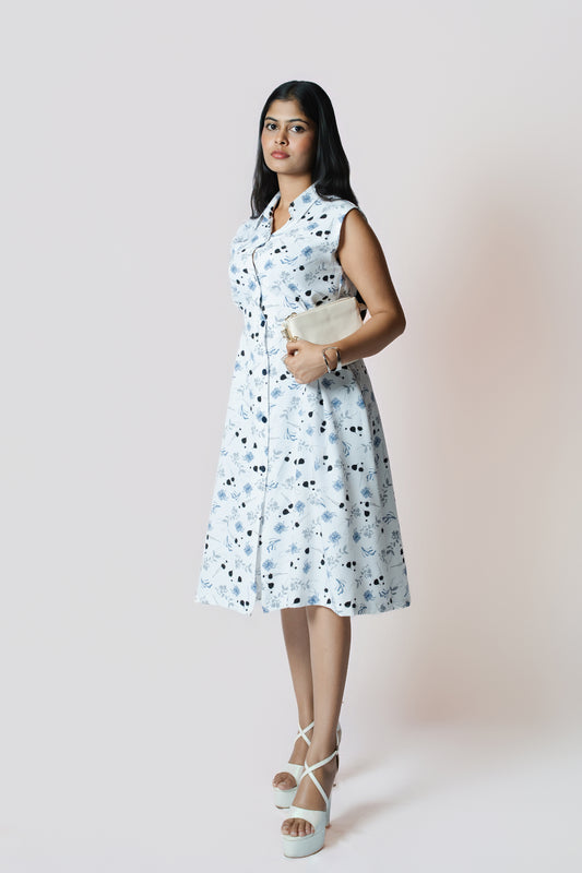 Petal Whirl Belted Dress: white sleeveless collared midi shirt dress with a scattered blue-black petal print and tie belt, front view