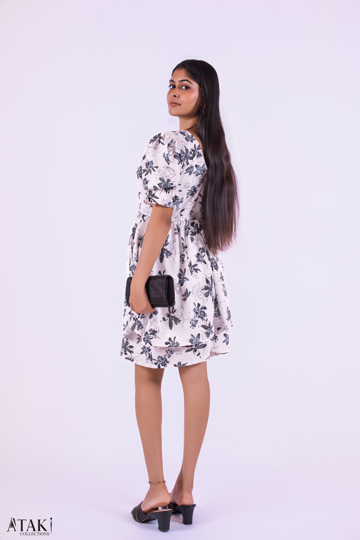 Luna Bloom Puff Sleeve Dress: white mini dress with a black floral print and puff sleeves, side view