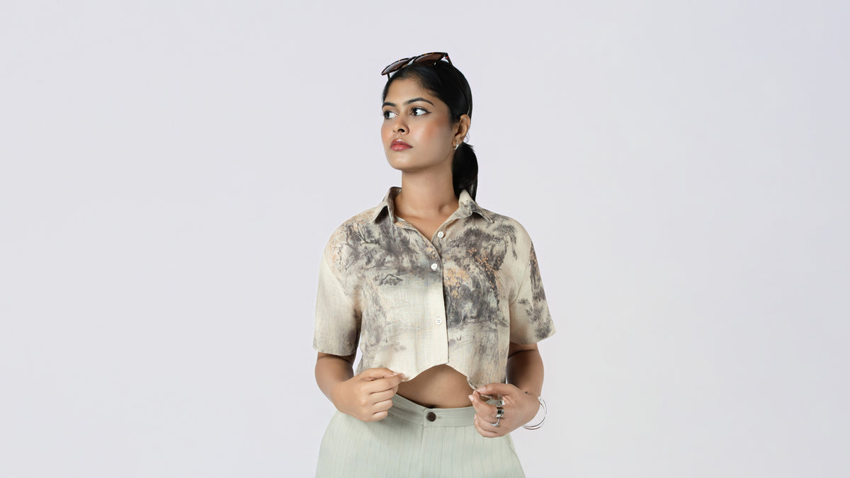 Model in a cropped brushstroke-print shirt and sage trousers